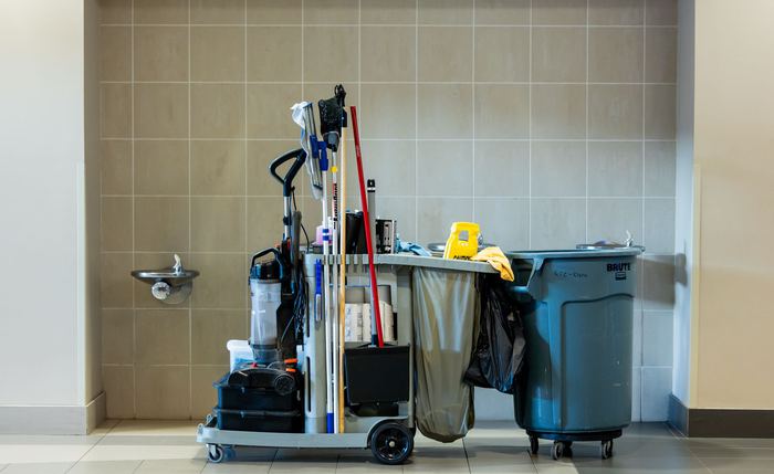 A professional cleaning trolley with equipment and supplies